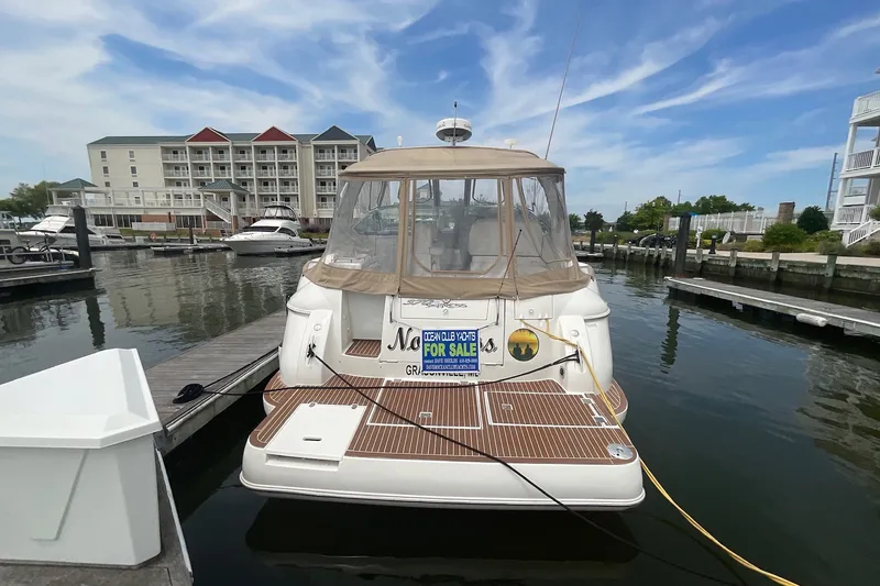 Slide: The Image of 2006 Cruisers Yachts 370 Express docked, for sale, with scenic marina backdrop. - 5