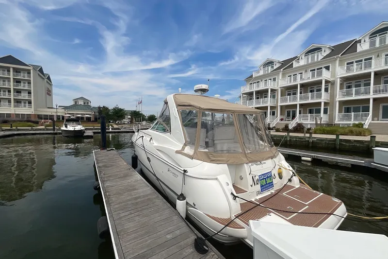 Slide: The Image of 2006 Cruisers Yachts 370 Express docked at marina, for sale sign visible. - 6