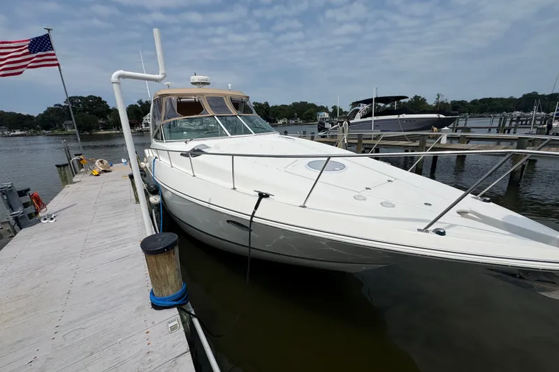 Slide: The Image of 2006 Cruisers Yachts 370 Express docked at marina with American flag. - 3