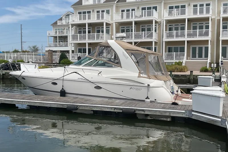 Slide: The Image of 2006 Cruisers Yachts 370 Express docked near waterfront apartments. - 8
