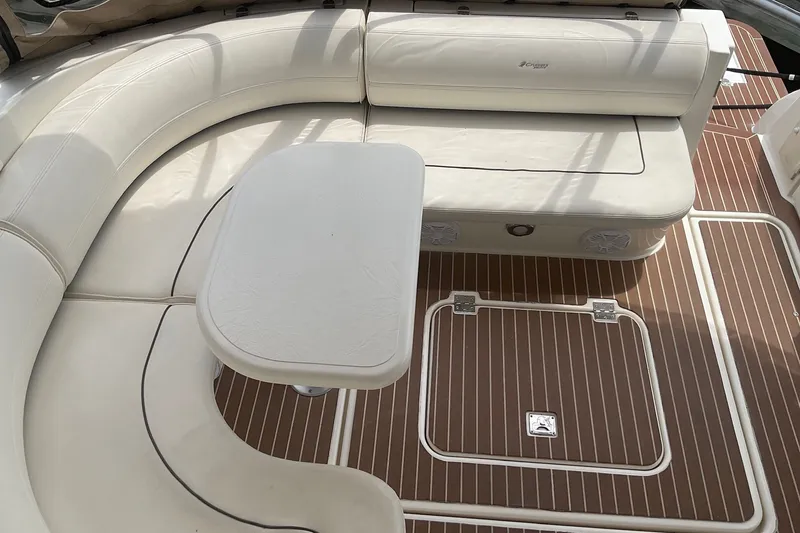 Slide: The Image of 2006 Cruisers Yachts 370 Express interior with white seating and wooden flooring. - 9
