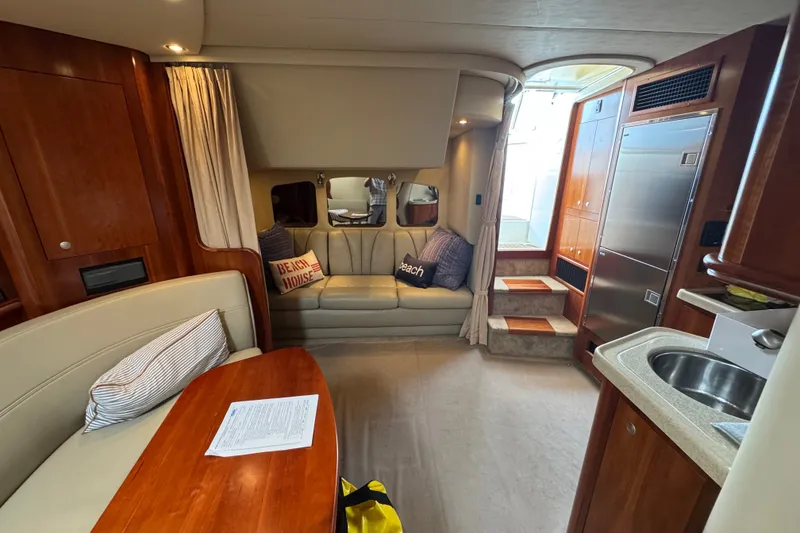 Slide: The Image of Interior of 2006 Cruisers Yachts 370 Express, featuring cozy seating and modern amenities. - 21