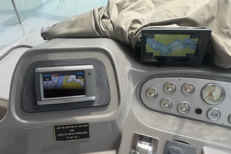 Slide: The Image of Dashboard of a 2006 Cruisers Yachts 370 Express with navigation screens and gauges. - 17