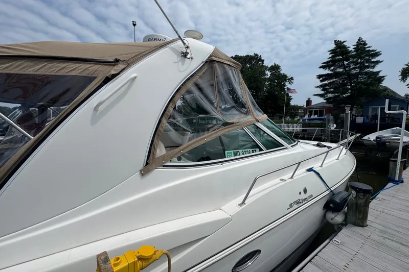 Slide: The Image of 2006 Cruisers Yachts 370 Express docked, featuring sleek design and canopy. - 2