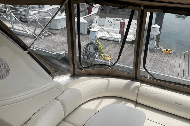 Slide: The Image of 2006 Cruisers Yachts 370 Express interior with dockside view and comfortable seating. - 14
