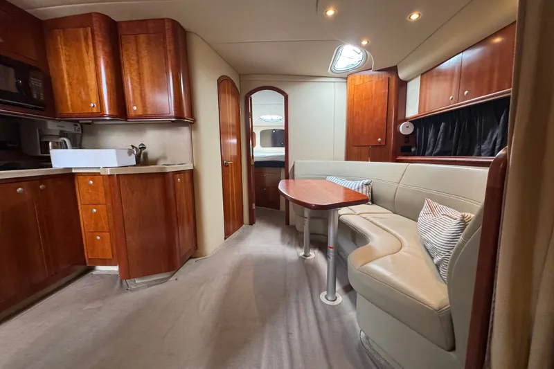 Slide: The Image of Luxurious 2006 Cruisers Yachts 370 Express interior with elegant wood cabinetry and plush seating. - 23