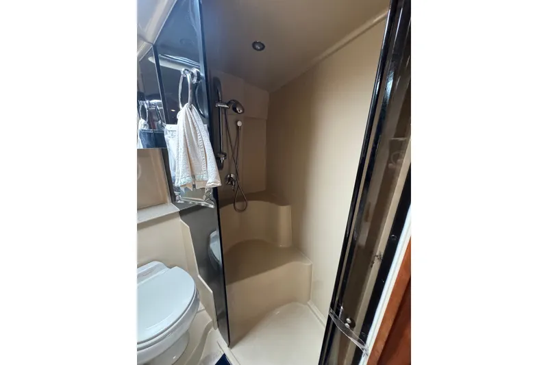 Slide: The Image of Bathroom interior of 2006 Cruisers Yachts 370 Express, featuring shower and toilet. - 33