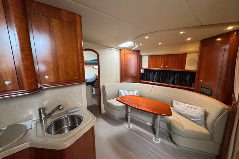 Slide: The Image of Luxurious interior of 2006 Cruisers Yachts 370 Express with wood cabinetry and cozy seating area. - 27