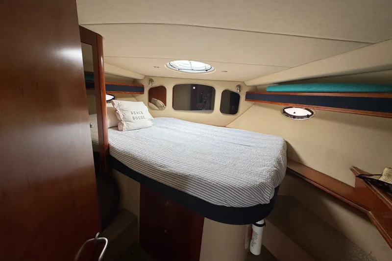 Slide: The Image of Cozy cabin interior of 2006 Cruisers Yachts 370 Express with bed and portholes. - 29