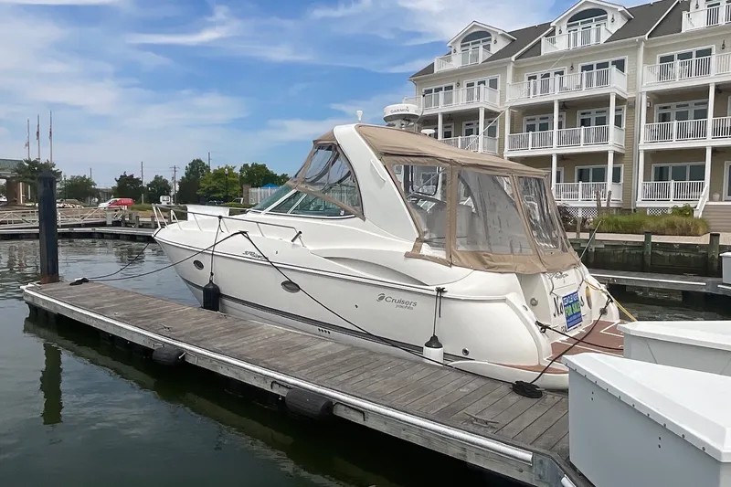 Slide: The Image of 2006 Cruisers Yachts 370 Express docked at marina with waterfront buildings. - 7