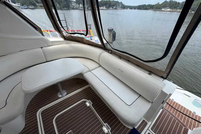 Slide: The Image of Interior of 2006 Cruisers Yachts 370 Express with white seating and scenic water view. - 11