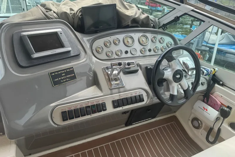 Slide: The Image of Helm of 2006 Cruisers Yachts 370 Express with steering wheel and navigation instruments. - 16