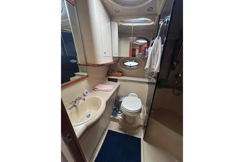 Slide: The Image of Bathroom interior of 2006 Cruisers Yachts 370 Express, featuring sink, toilet, and shower. - 32