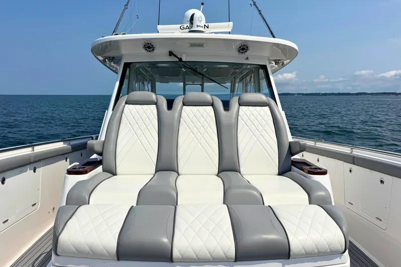 Slide: The Image of 2023 Everglades 455 Center Console boat with luxurious seating on open water. - 47