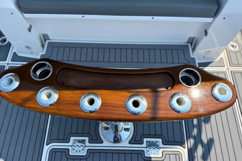 Slide: The Image of 2023 Everglades 455 Center Console boat with wooden rod holders on deck. - 21