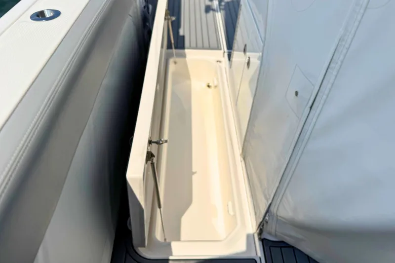 Slide: The Image of Storage compartment on 2023 Everglades 455 Center Console boat, featuring sleek design and durable materials. - 57