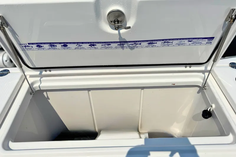 Slide: The Image of Open storage compartment on 2023 Everglades 455 Center Console boat. - 67
