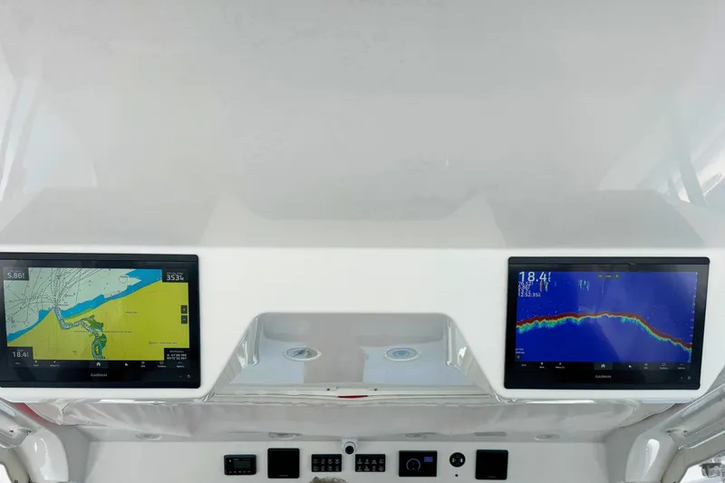 Slide: The Image of 2023 Everglades 455 Center Console dashboard with dual navigation screens. - 27
