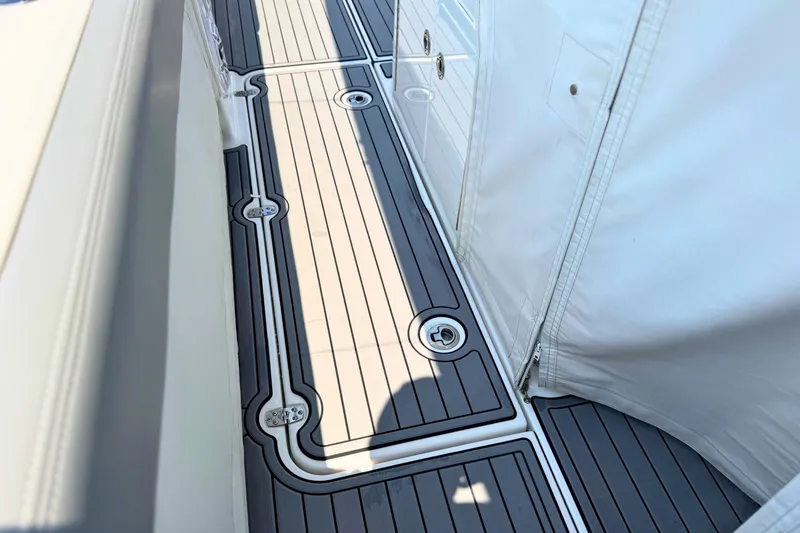 Slide: The Image of 2023 Everglades 455 Center Console boat deck with sleek, modern design and white accents. - 56
