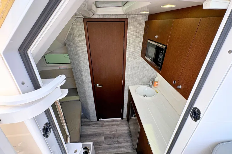 Slide: The Image of Interior of 2023 Everglades 455 Center Console boat with kitchenette and seating area. - 39