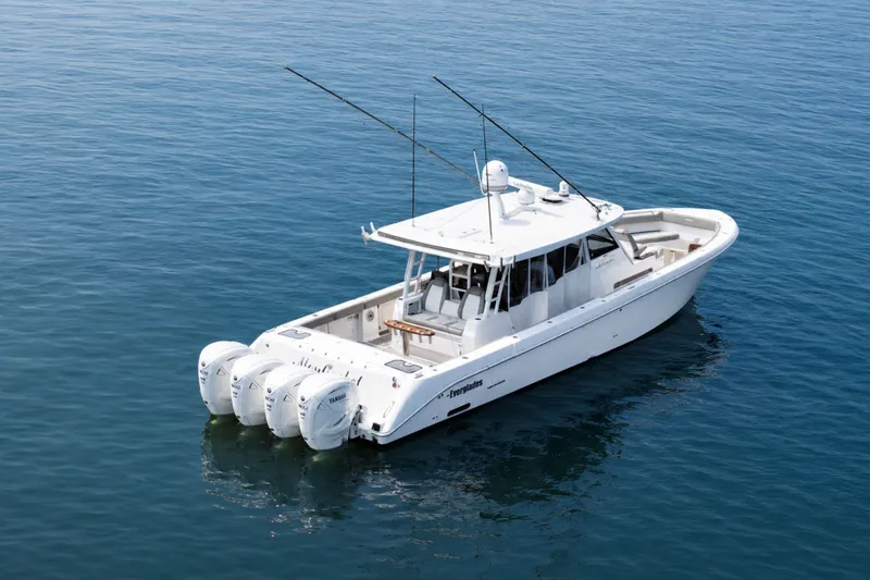 Slide: The Image of 2023 Everglades 455 Center Console boat on calm blue water. - 5