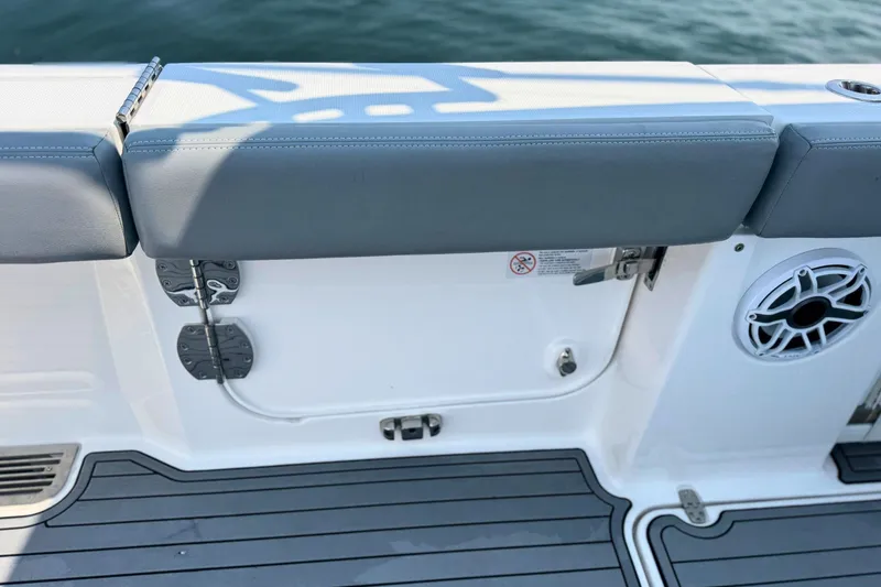 Slide: The Image of 2023 Everglades 455 Center Console boat interior with cushioned seating and speaker. - 17