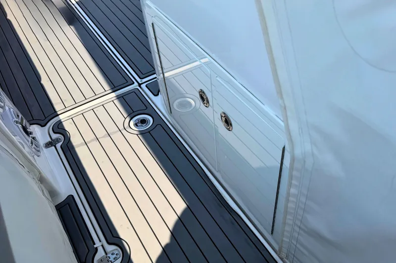 Slide: The Image of 2023 Everglades 455 Center Console boat deck with sleek, modern design and storage compartments. - 58