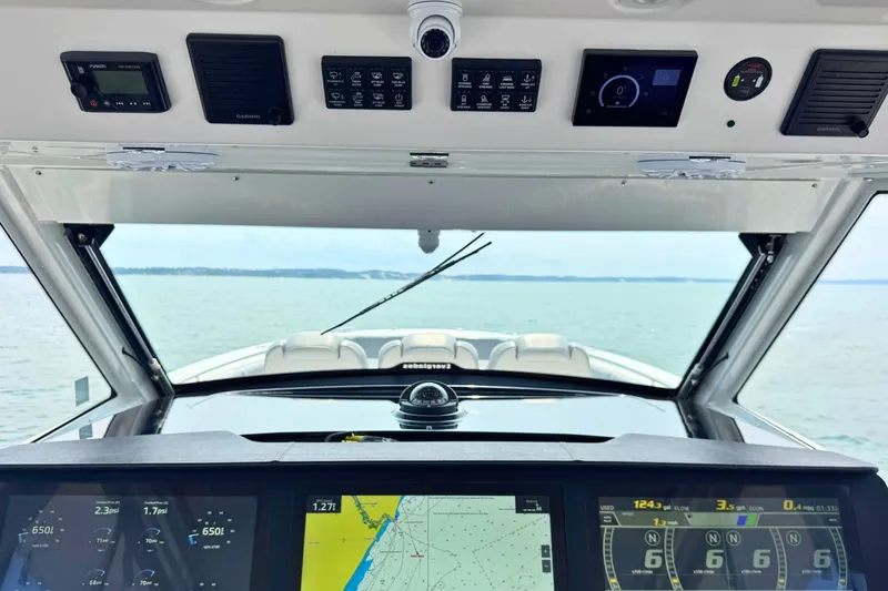 Slide: The Image of 2023 Everglades 455 Center Console boat dashboard with navigation screens and controls. - 32