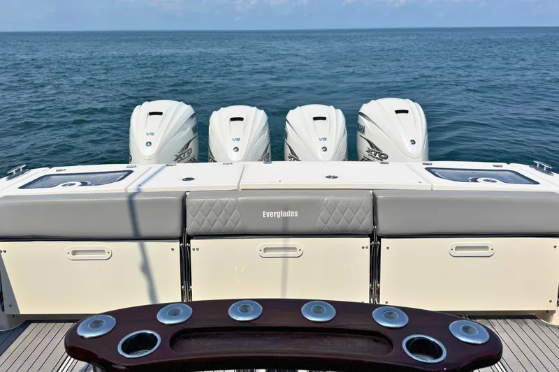 Slide: The Image of 2023 Everglades 455 Center Console boat with four powerful outboard engines on open water. - 62