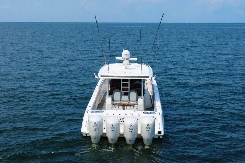 Slide: The Image of 2023 Everglades 455 Center Console boat with four engines on open water. - 8