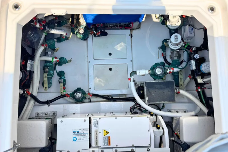 Slide: The Image of Engine compartment of 2023 Everglades 455 Center Console boat, showcasing mechanical components. - 70