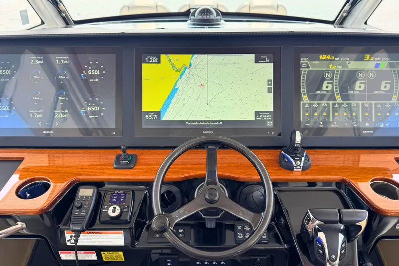 Slide: The Image of 2023 Everglades 455 Center Console dashboard with advanced navigation and control systems. - 31