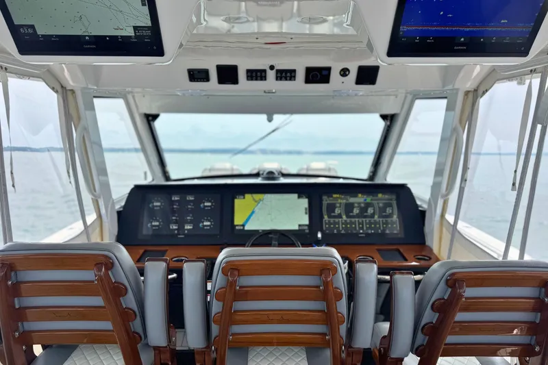 Slide: The Image of Interior view of 2023 Everglades 455 Center Console boat cockpit with advanced navigation displays. - 26