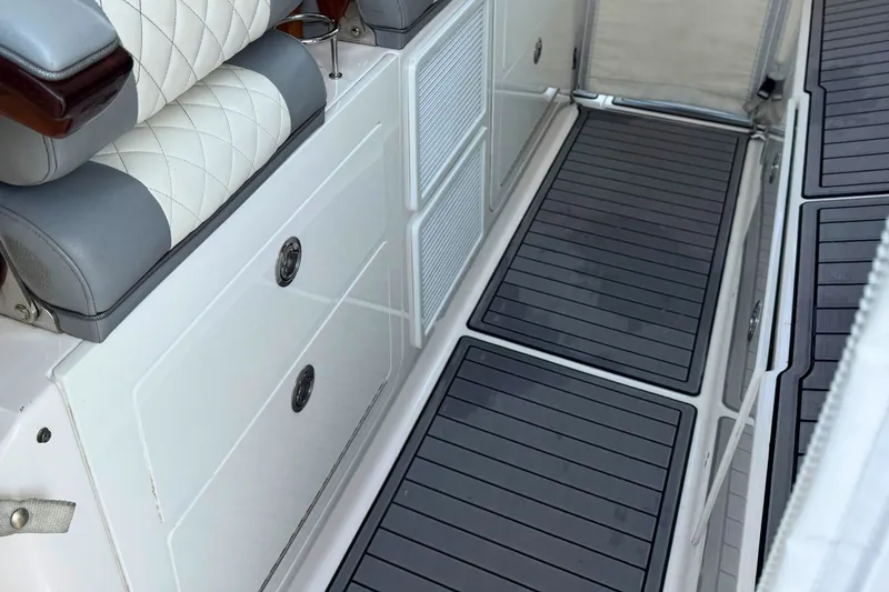 Slide: The Image of 2023 Everglades 455 Center Console interior with cushioned seating and non-slip flooring. - 30