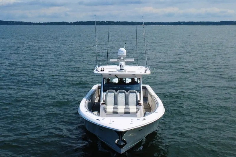 Slide: The Image of 2023 Everglades 455 Center Console boat cruising on open water. - 7