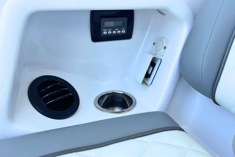 Slide: The Image of 2023 Everglades 455 Center Console interior with cup holder and control panel. - 24