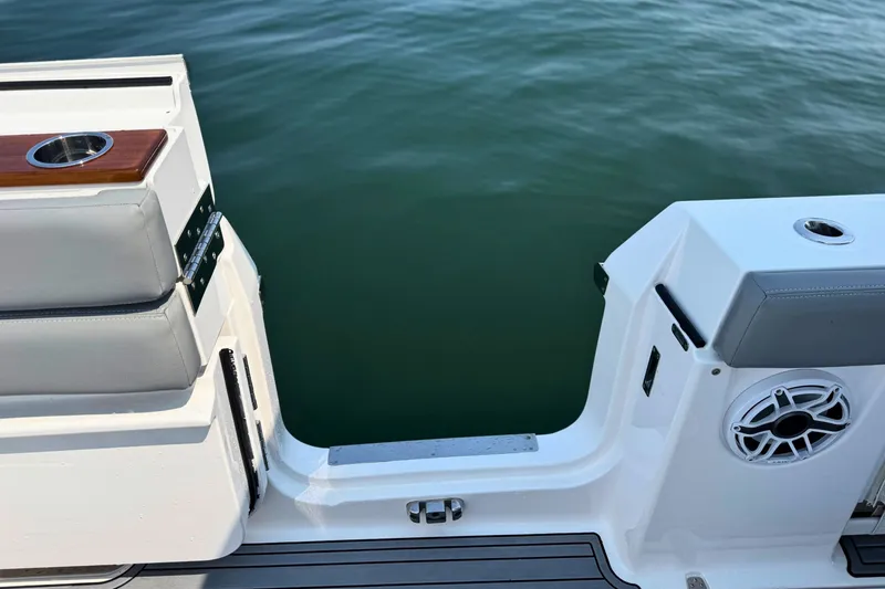 Slide: The Image of 2023 Everglades 455 Center Console boat deck with seating and cup holders. - 18