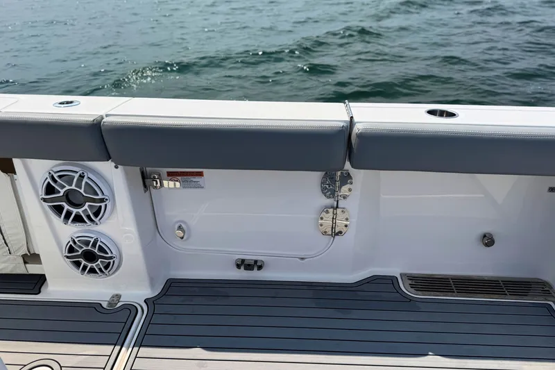 Slide: The Image of 2023 Everglades 455 Center Console boat interior with speakers and cushioned seating. - 13