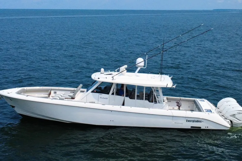 Slide: The Image of 2023 Everglades 455 Center Console boat cruising on open water. - 1