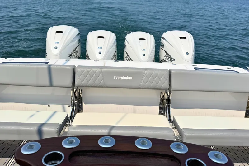 Slide: The Image of 2023 Everglades 455 Center Console boat with four powerful outboard engines on the water. - 12