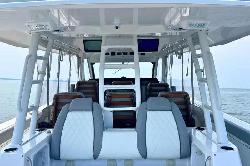 Slide: The Image of 2023 Everglades 455 Center Console boat interior with seating and ocean view. - 22