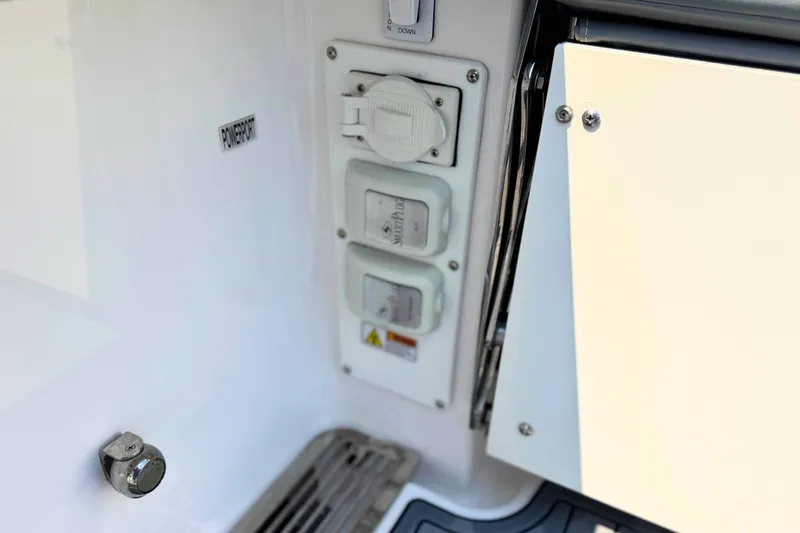 Slide: The Image of Powerport panel on 2023 Everglades 455 Center Console boat, featuring multiple outlets. - 16