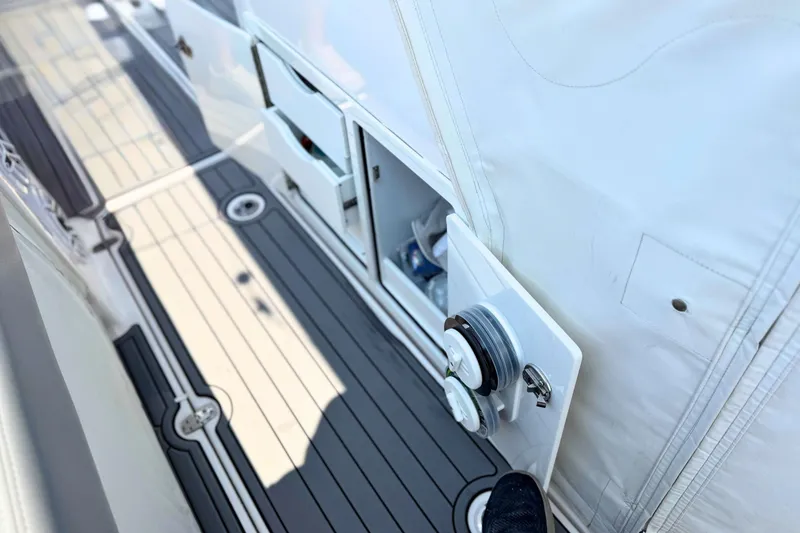 Slide: The Image of 2023 Everglades 455 Center Console boat deck with storage compartments and sleek design. - 59