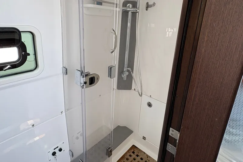 Slide: The Image of Modern shower area inside 2023 Everglades 455 Center Console boat. - 44