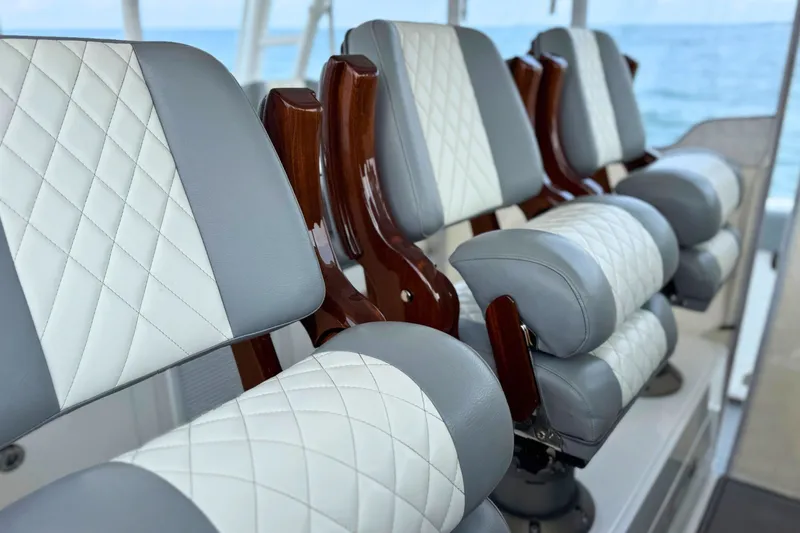 Slide: The Image of Luxury seating on 2023 Everglades 455 Center Console boat, featuring quilted upholstery. - 35