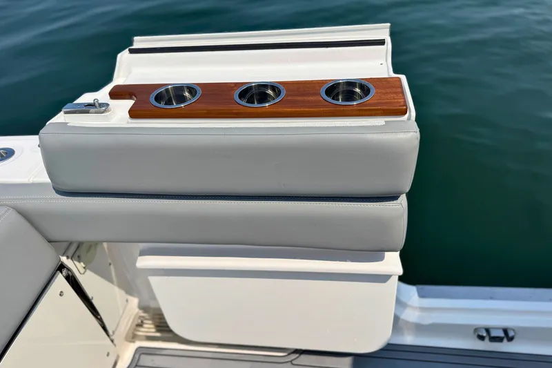 Slide: The Image of 2023 Everglades 455 Center Console boat with cushioned seating and cup holders on deck. - 19