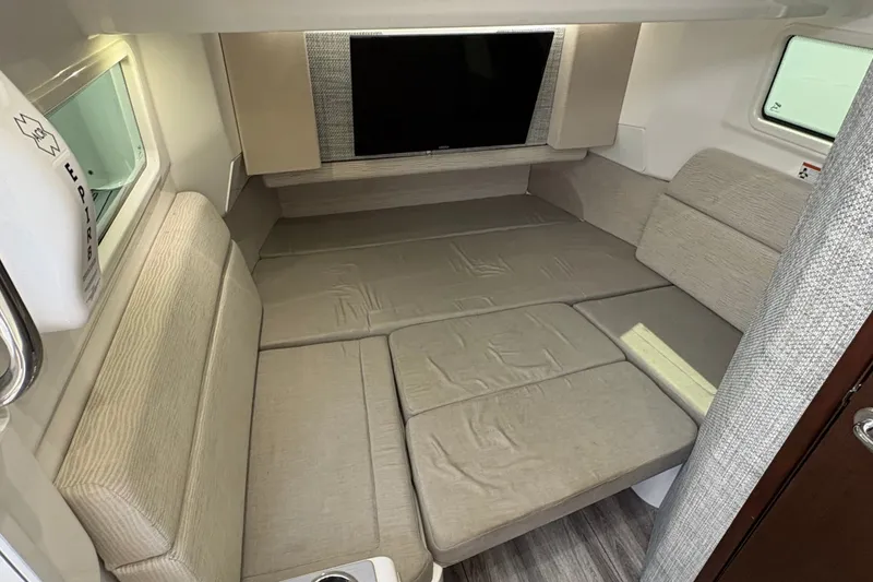 Slide: The Image of Interior cabin of 2023 Everglades 455 Center Console boat with beige seating. - 40