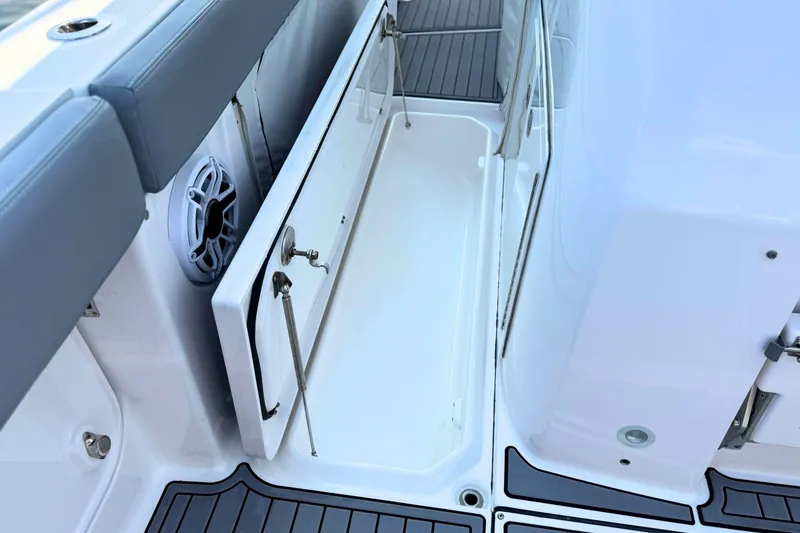 Slide: The Image of 2023 Everglades 455 Center Console boat interior with storage compartment and speaker. - 61