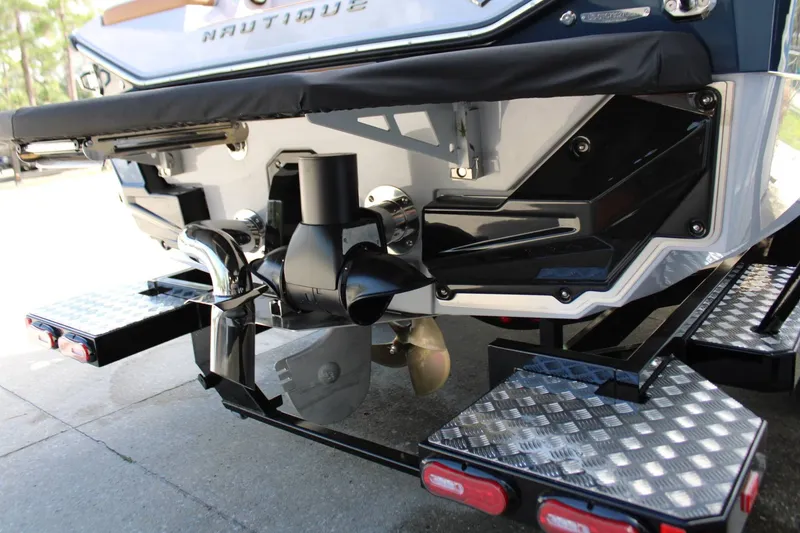 Slide: The Image of The image shows the stern of a Nautique Super Air Nautique S23 boat with propeller and platform. - 39