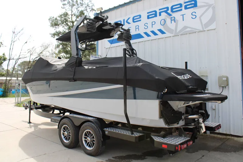 Slide: The Image of A modern boat on a trailer in front of a building, featuring a black cover. - 37